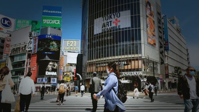 Japan's economy contracted less than earlier announced